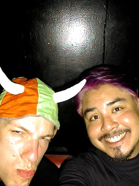 09 karl mohr and joey devilla Karl Mohr in a cloth cap with horns and Joey deVilla in a black mock turtleneck.